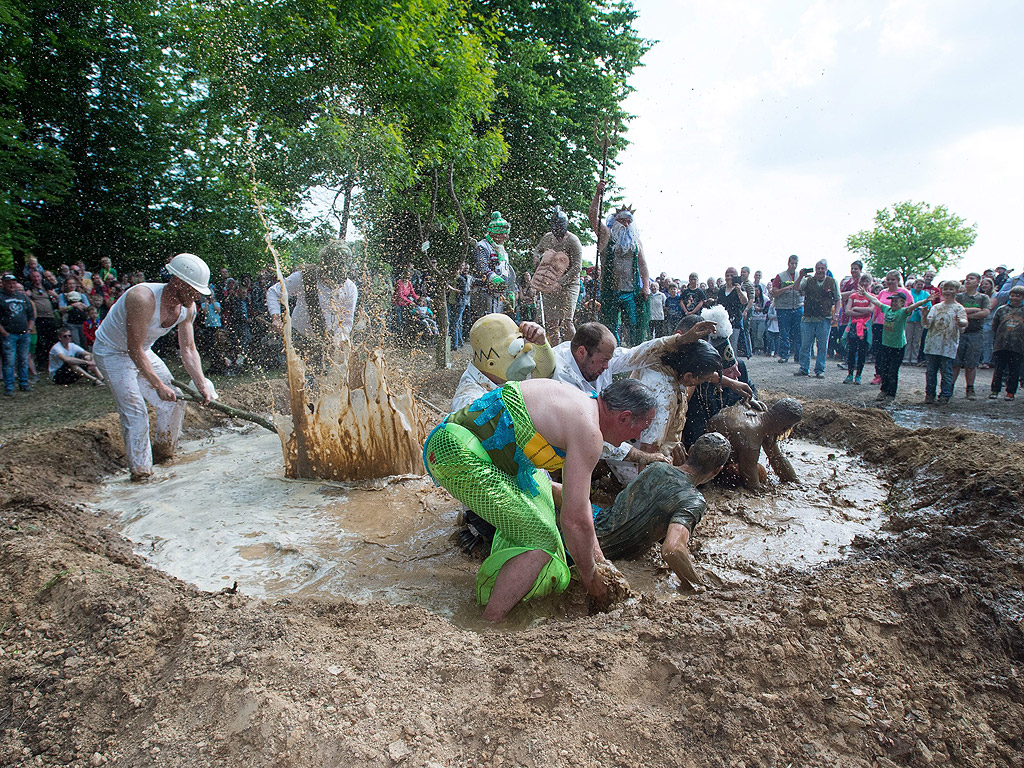 Участници се валят в кална локва по време на така нареченият "Dirty Pig Festival" близо до Хергисдорф, Германия. С този обичай селяните искат да прогонят зимата.