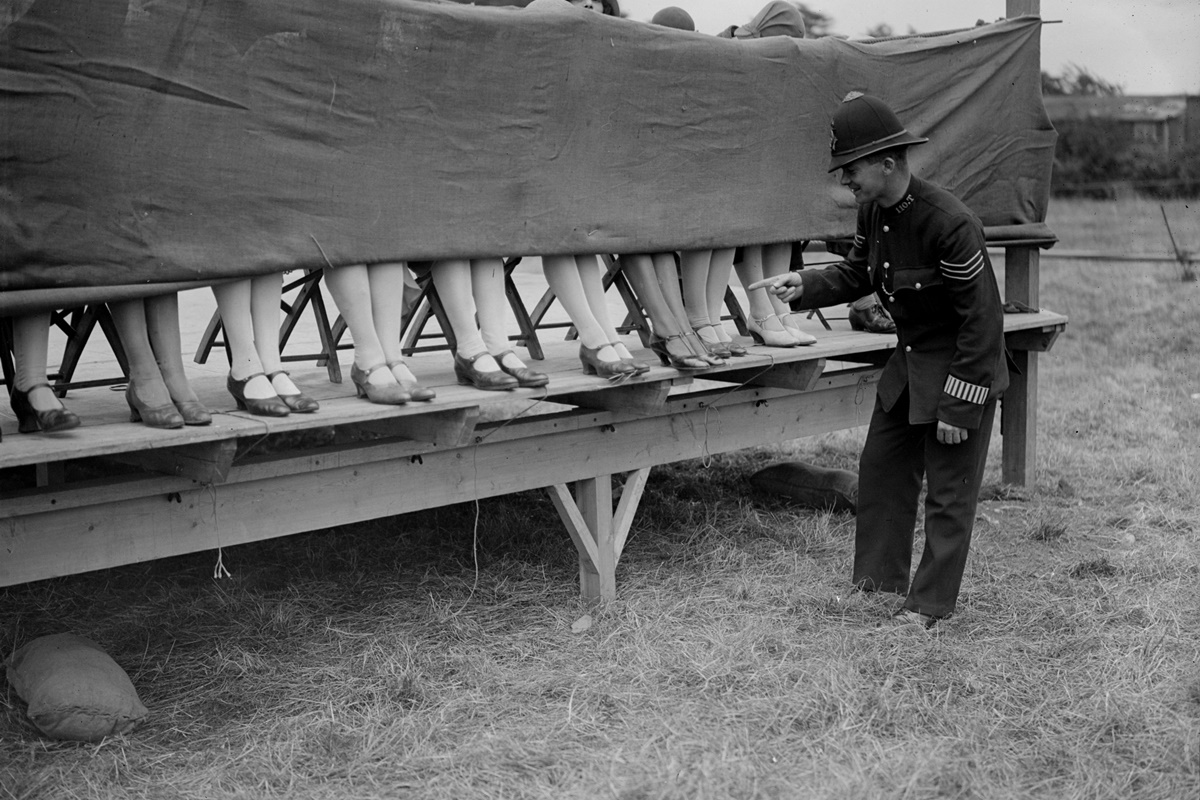 10 юли 1930 г.: Полицай оценява глезените на участнички в конкурс за най-хубави глезени в Лондон, Англия.