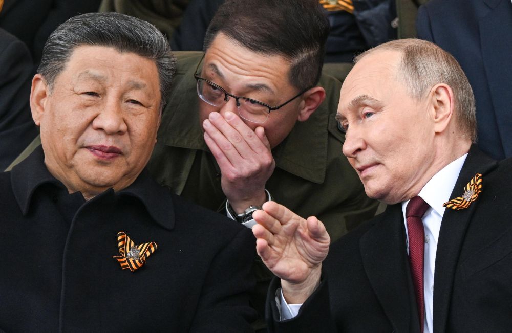 Си Дзинпин и Владимир Путин разговарят по време на парада